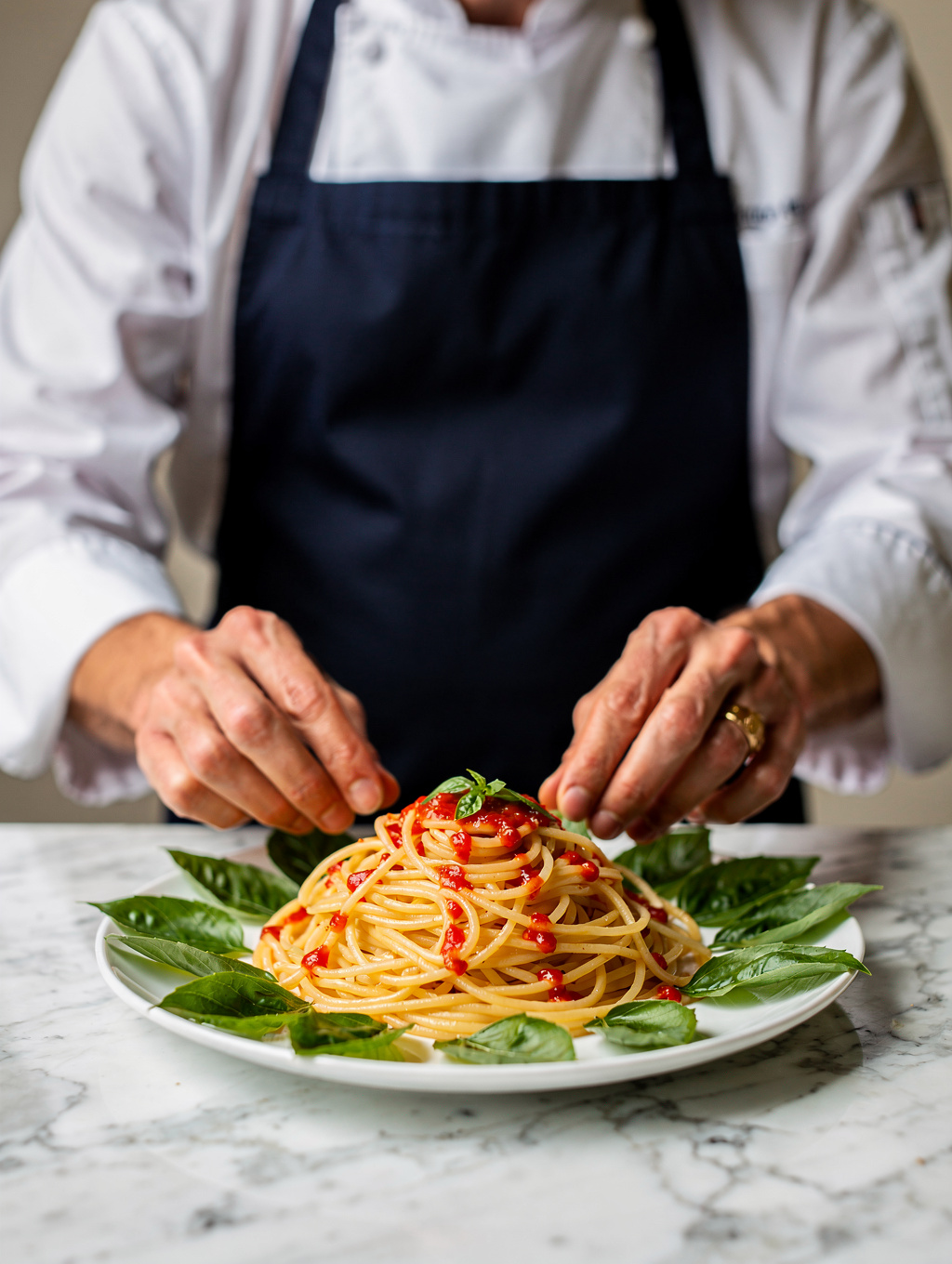 Chef plating a fresh seasonal Italian pasta dish